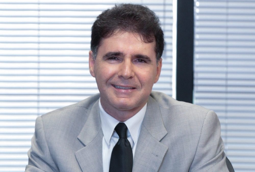 subprocurador-geral Lucas Furtado sorrindo para a câmera, de roupa social cinza