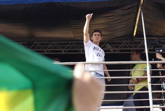 Nikolas Ferreira fazendo joinha em cima de trio elétrico