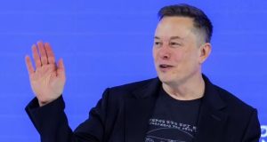 Elon Musk acenando e sorrindo