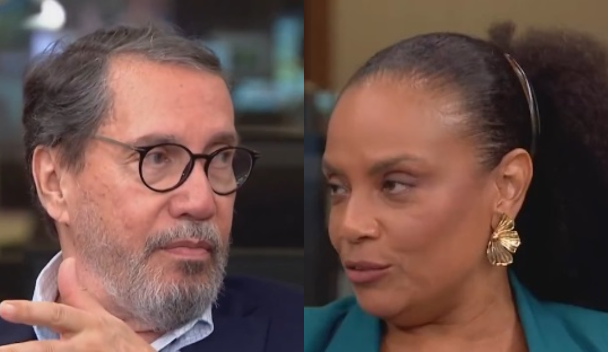 jornalistas Merval Pereira e Flávia Oliveira falando, sérios, se olhando