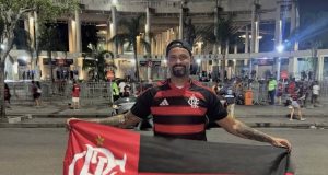 goleiro Bruno sorrindo para a câmera, com bandeira do Flamengo