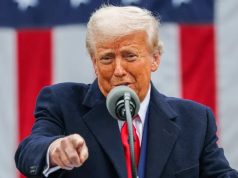 O presidente americano Donald Trump falando em microfone e apontando pra frente