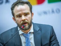 ministro da Fazenda, Dario Durigan, falando em microfone, sério, sem olhar para a câmera