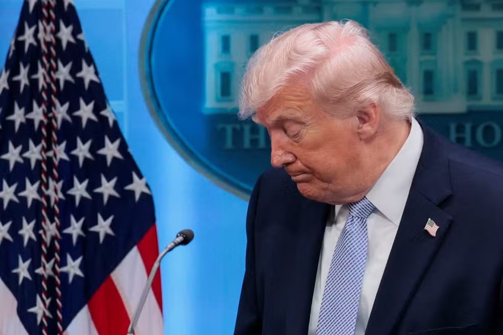 presidente Donald Trump de olhos fechados e cabeça abaixada
