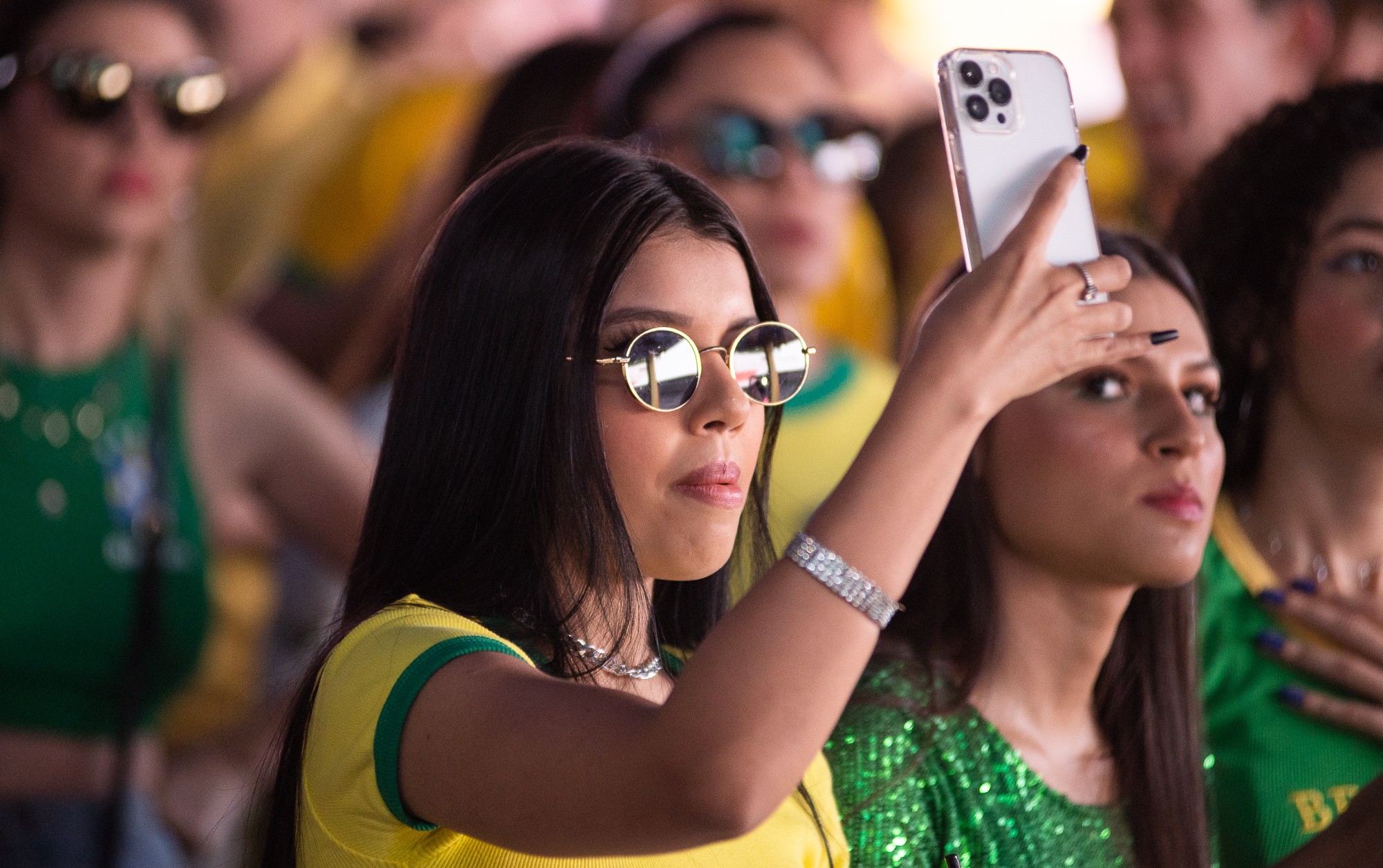 Torcedor com celular durante jogo do Brasil