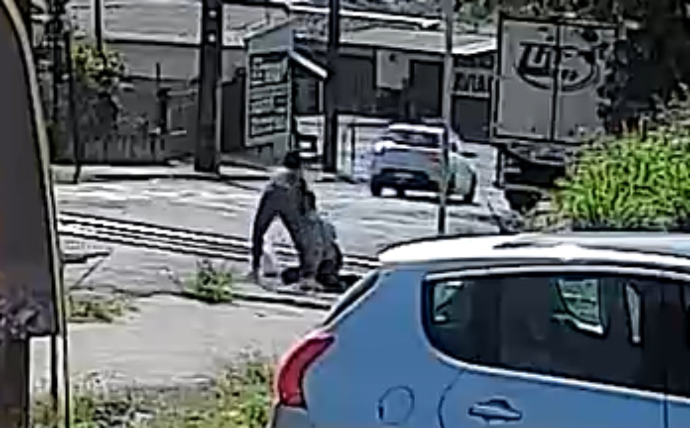 Mulher puxa homem dos trilhos em passagem de nível