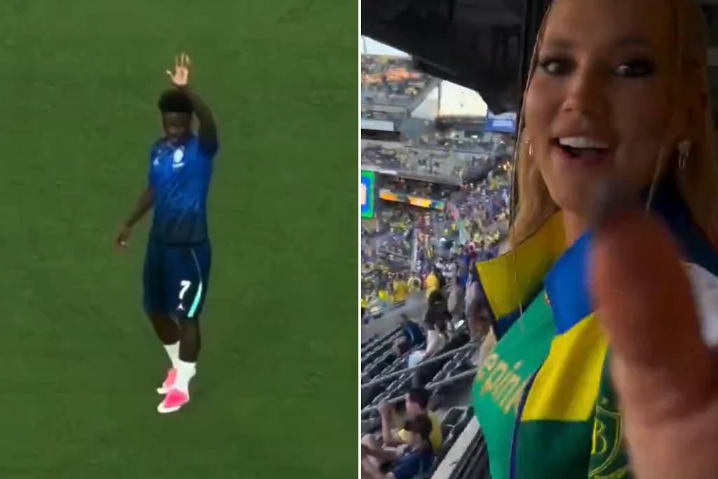 Vini Jr. acena para a arquibancada durante treino da seleção brasileira