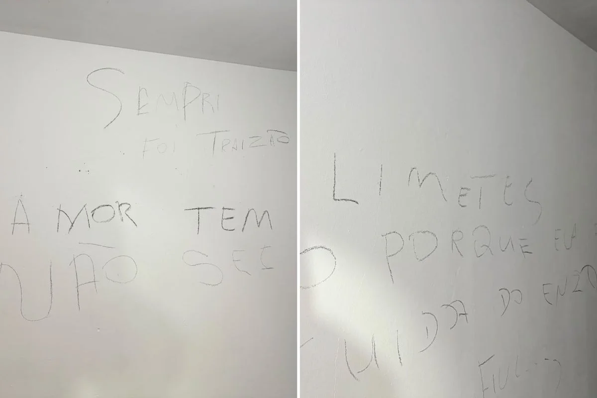 Frases escritas com carvão em parede de residência