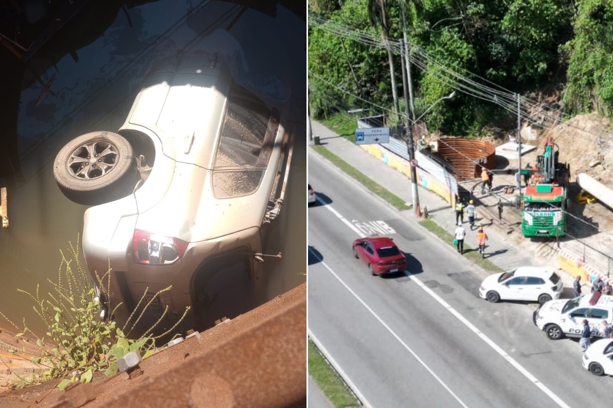 Carro parcialmente submerso em vala alagada em obra em Santos