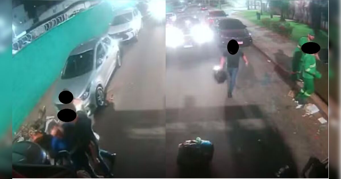 Caminhão de coleta de lixo em via urbana à noite