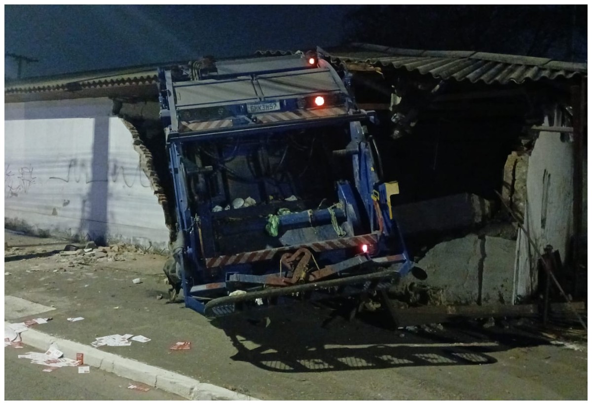 Caminhão de coleta de lixo parado após bater contra muro na Avenida do Estado
