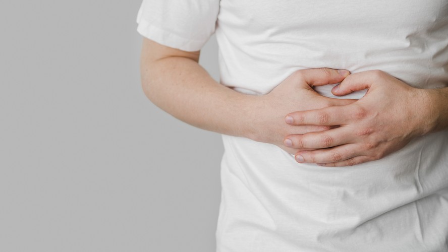 Homem com a mão sobre a barriga