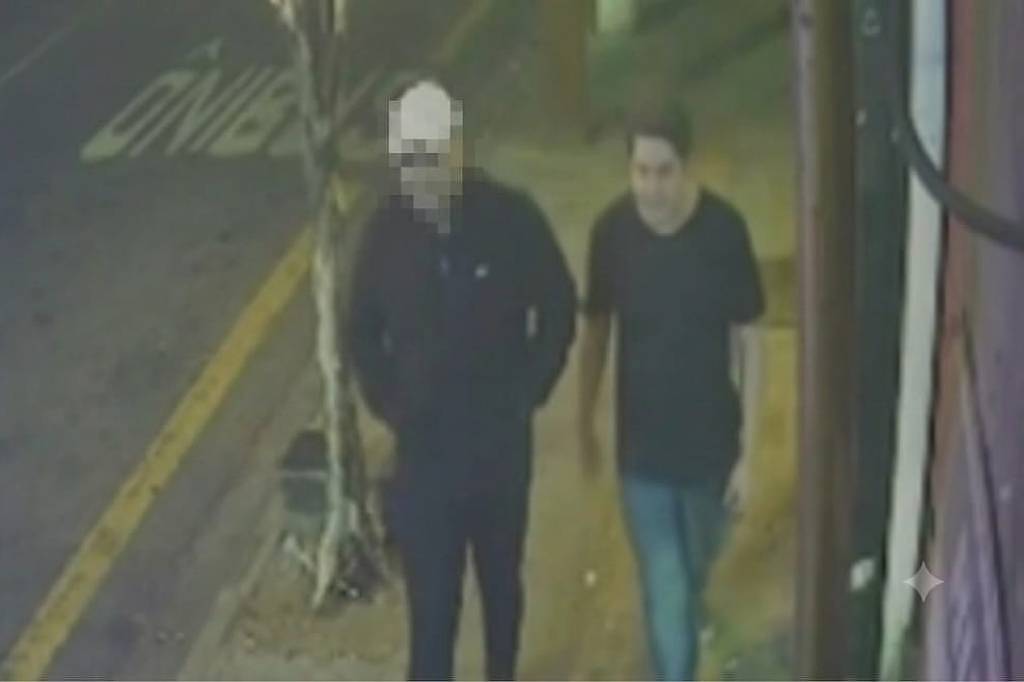 Pedro Ely Cordeiro dos Santos caminha ao lado de homem em calçada