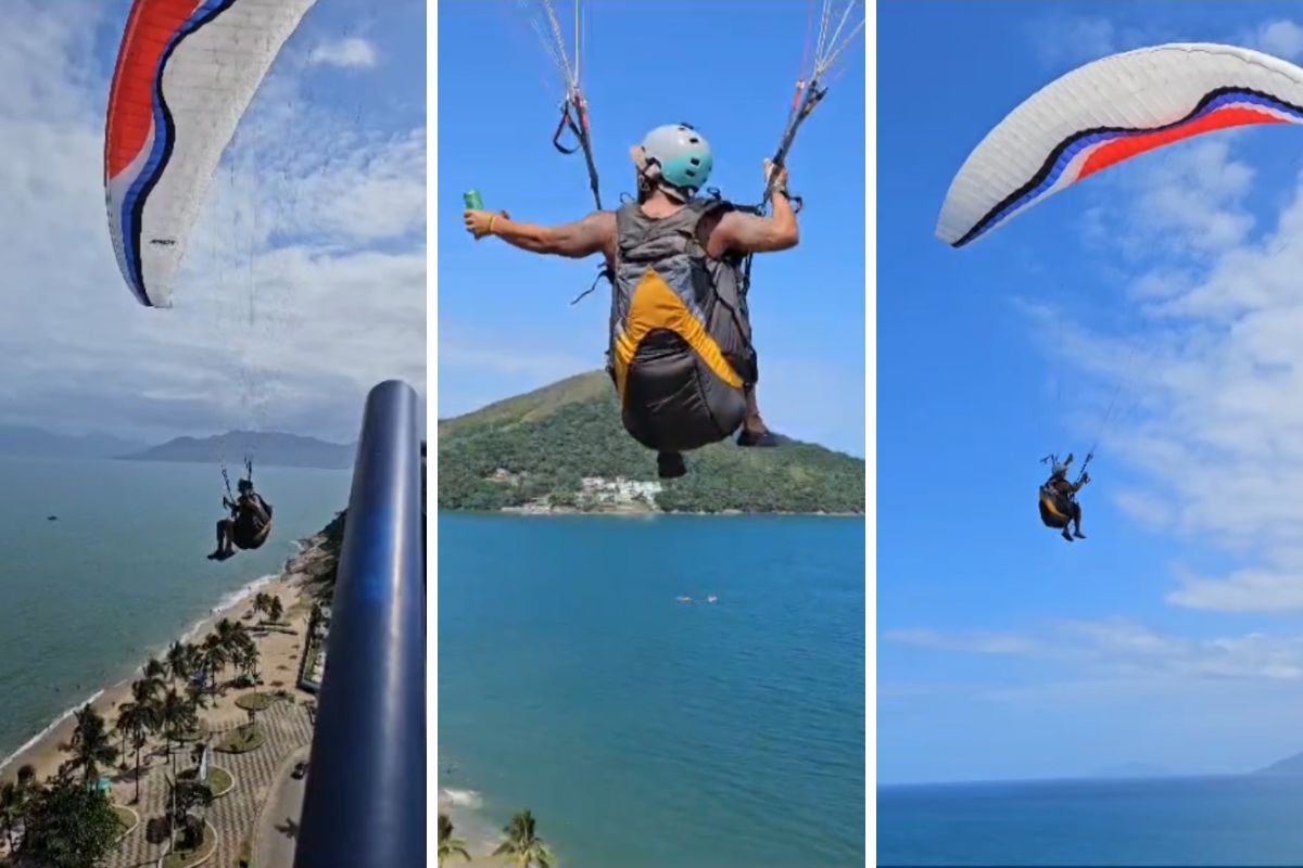 Piloto de parapente voa perto de prédio em Caraguatatuba