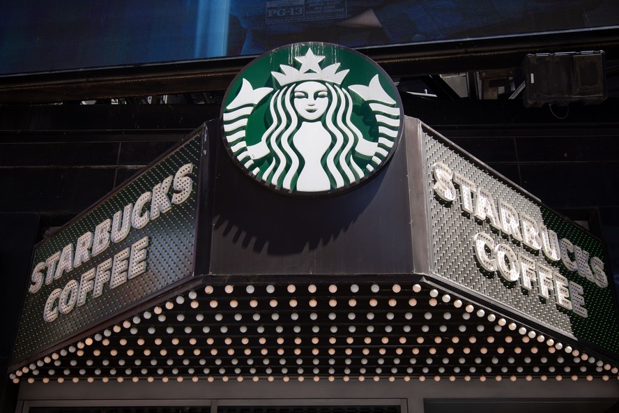 Cafeteria Starbucks com mesas e assentos para clientes