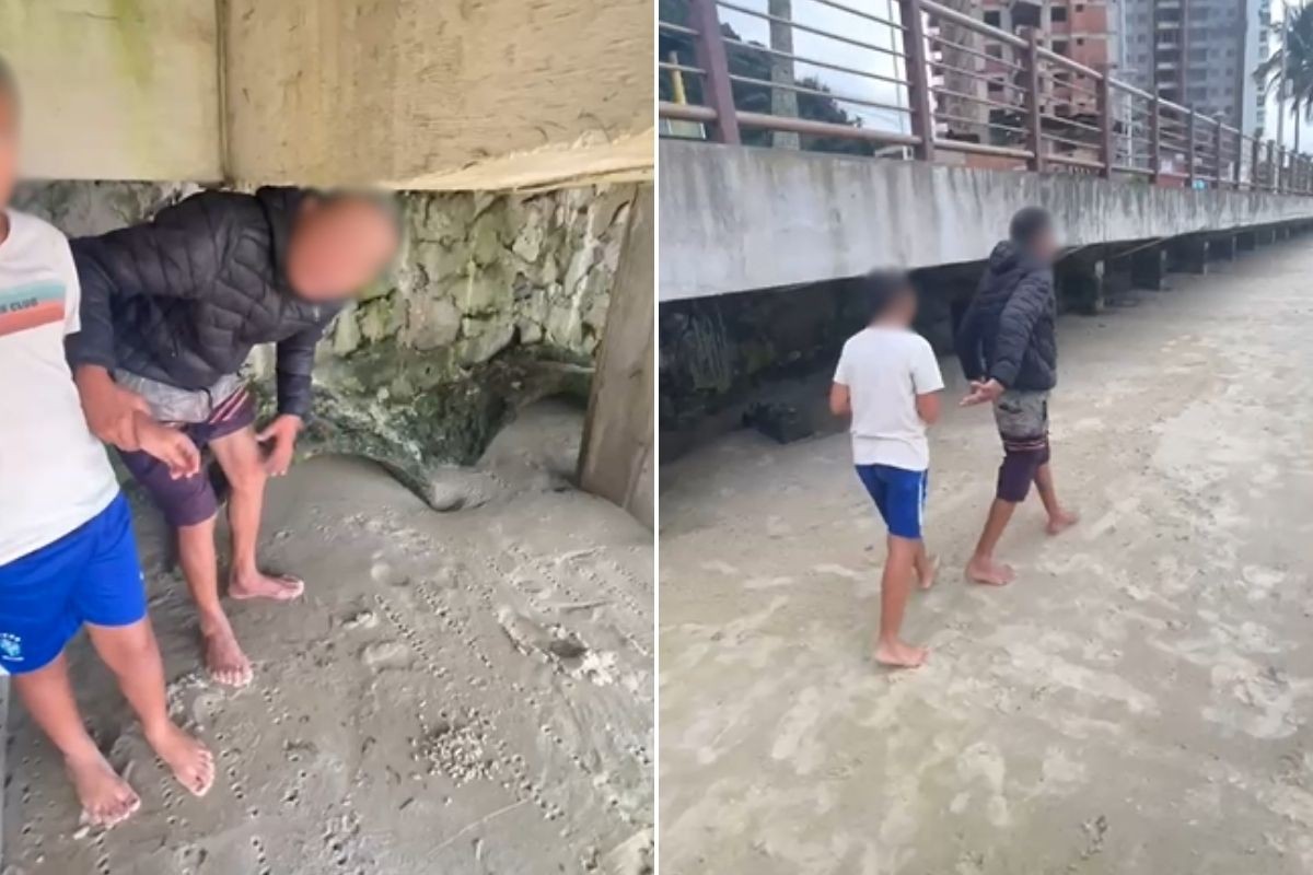 Joselito Vitor dos Santos ao lado de um garoto em praia do Guarujá