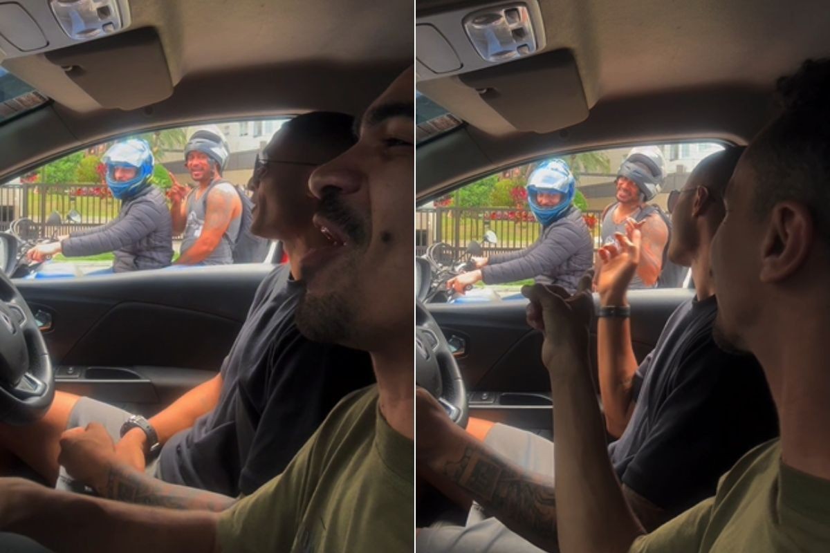 Dois amigos dançam dentro de carro parado em semáforo de Santos
