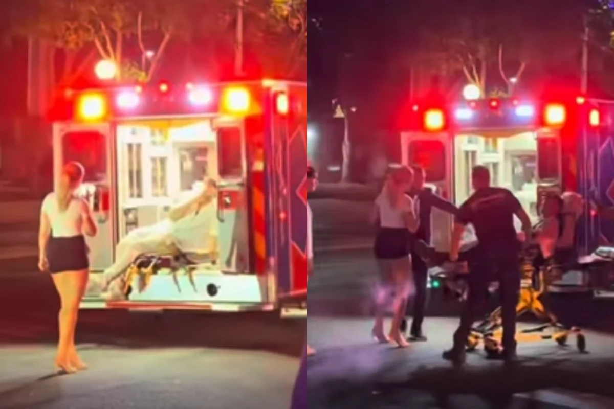Influenciador deitado em maca dentro de ambulância enquanto mulher tira foto