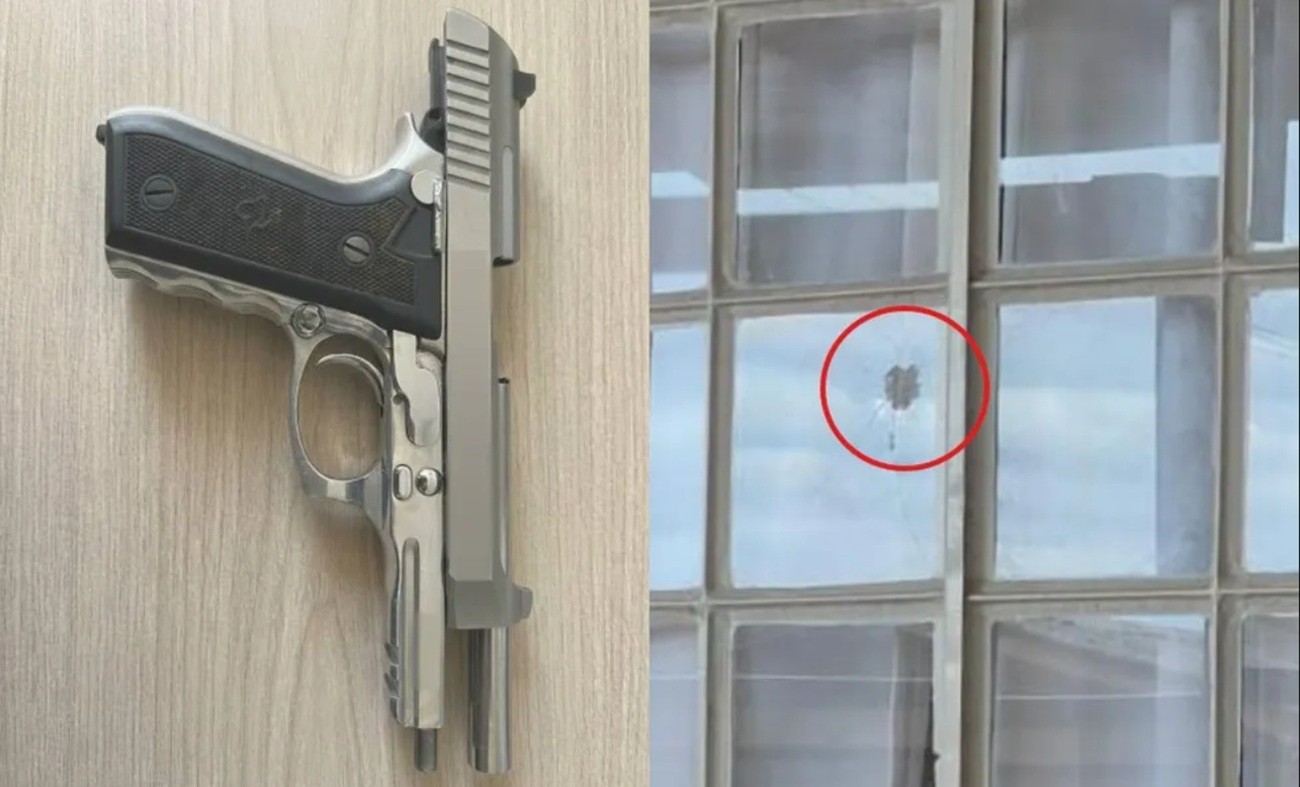 Pistola apreendida pela Polícia Civil e janela atingida por disparo em Chapecó